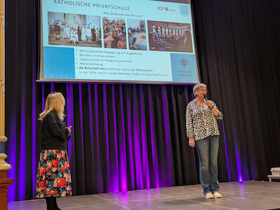Fr. Hofer erklärt auf der Bühne, was es bedeutet, eine katholische Privatschule zu sein.